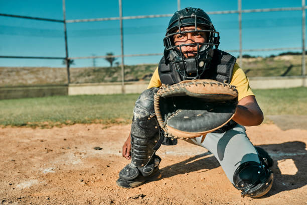 He's the one with the best catching skills Shot of the catcher sitting in position to catch the ball catchers mask stock pictures, royalty-free photos & images