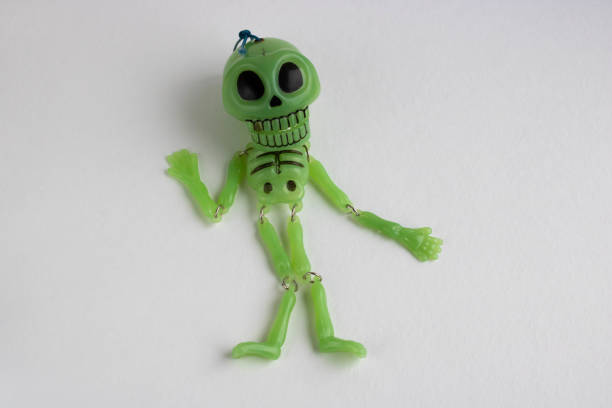 istock Halloween Background.A small green skeleton on a white background. Space for your text 1268744174