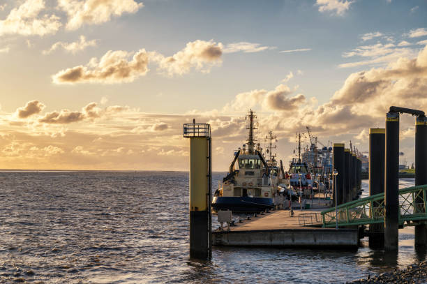 istock Sunset at the quay wall of Bremerhaven with ships 1268744297