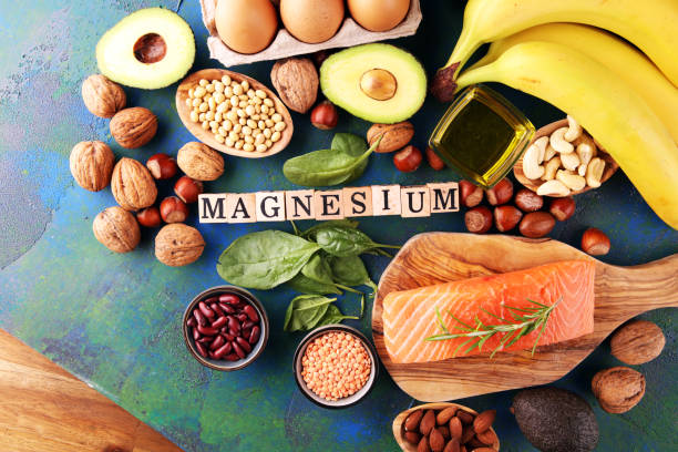 istock Products containing magnesium: bananas, almonds, avocado, nuts and spinach and eggs on background 1268756654