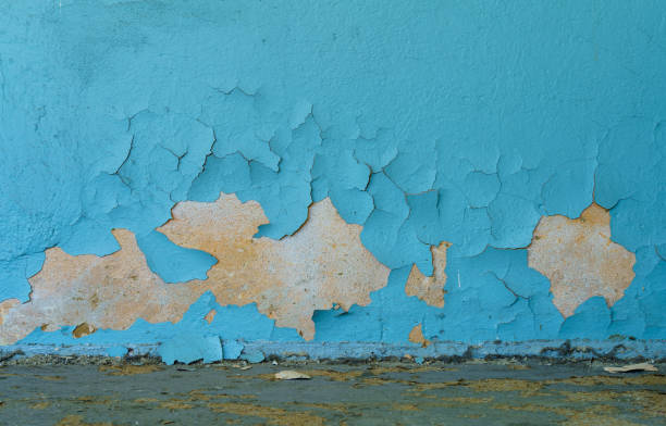istock The old cracked blue paint on a wall surface with messy ground 1268759327