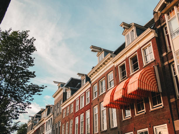 istock Facade of buildings with white windows in Amsterdam 1268760220