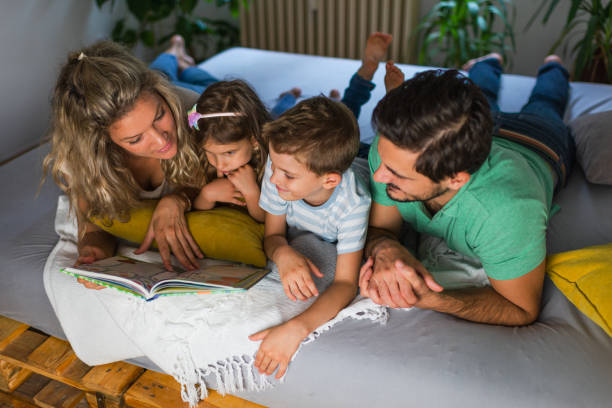 istock Young family enjoying book together 1268770783