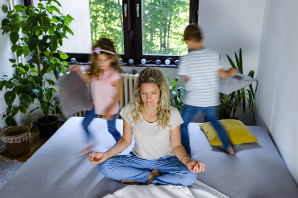 istock While noisy kids running young mother meditates 1268774634