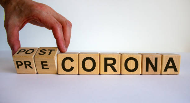 istock Hand turns cubes and changes the expression 'pre corona' to 'post corona'. Covid-19 pandemic concept. Beautiful white background. Copy space. 1268778311