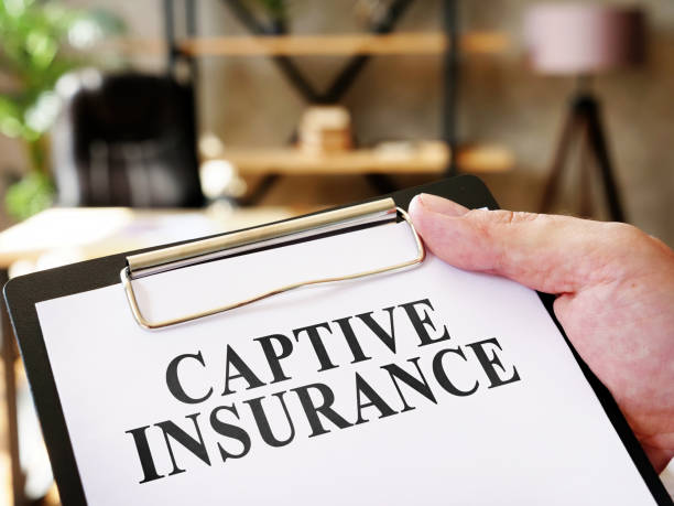 Hand holds document Captive insurance about insurance. Hand holds documents Captive insurance about insurance. trapped stock pictures, royalty-free photos & images