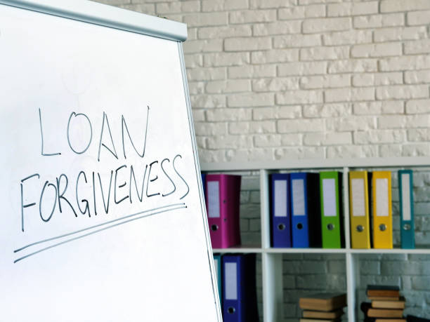 istock Loan forgiveness inscription on the white board in office. 1268778367
