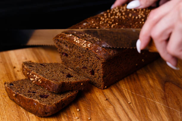 istock Homemade black bread on a black background. Photo in section. 1268778564