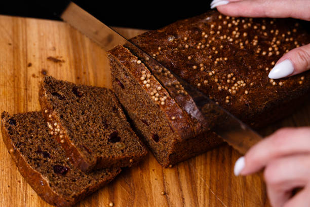istock Homemade black bread on a black background. Photo in section. 1268778575