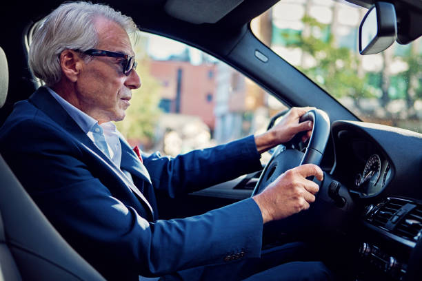 istock Businessman is driving in a city traffic 1268778740