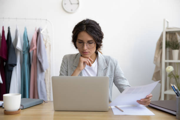 istock Thoughtful fashion designer businesswoman analyzing color patterns. 1268788573