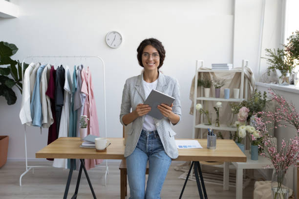 istock Portrait of young decorator in glasses leaning at table. 1268788610