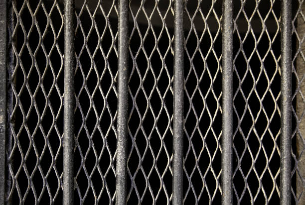 Iron bars with grating Iron bars with window grille, protection and security, construction dungeon medieval prison prison cell stock pictures, royalty-free photos & images