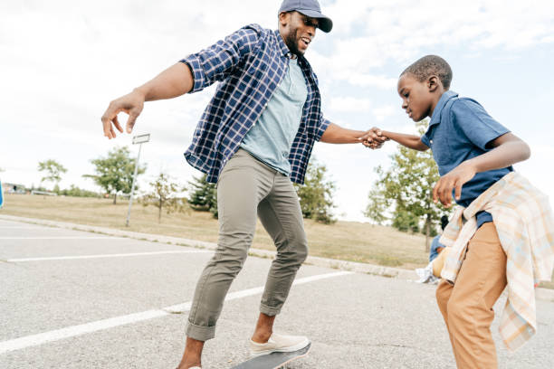 istock Authentic family moments - dad and son on skateboards 1268792290