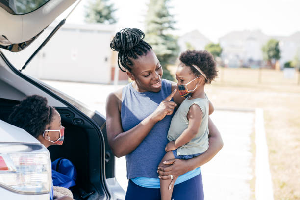 istock Mom helps to put masks on her daugher 1268792297