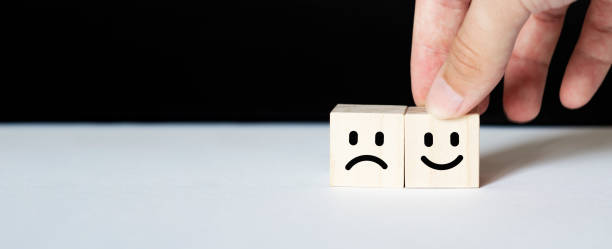 istock Close up customer hand choose smiley face and blurred sad face icon on wood cube, Service rating, satisfaction concept. 1268792367