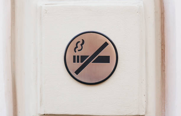 istock No smoking sign, metallic plate on a wall, toned 1268793460