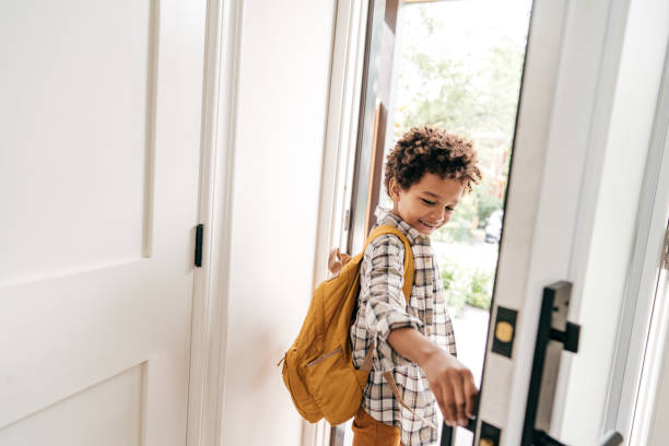Little student closing door behind himself