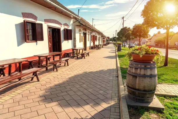 cityscape of Villany Hungary with barrels and cellers on the walking street .