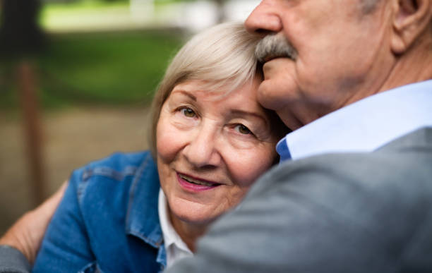 istock Happy senior couple in love sitting outdoors, midsection. 1268802931