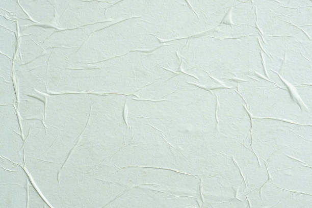 istock Crumpled white paper. Blank street poster texture. 1268815024