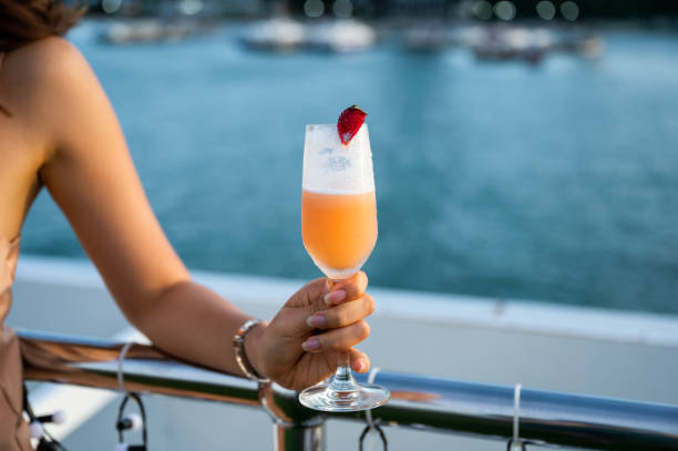 istock Woman hand holding mixed berry cocktail on rooftop restaurant 1268815603