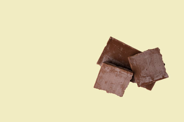 istock spoiled broken chocolate bar covered with white coating on an isolated light background. greasy chocolate 1268840884