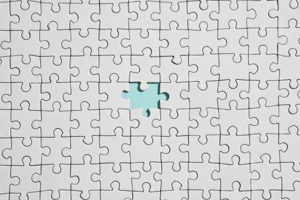 istock Background of white puzzle with missing piece 1268843651