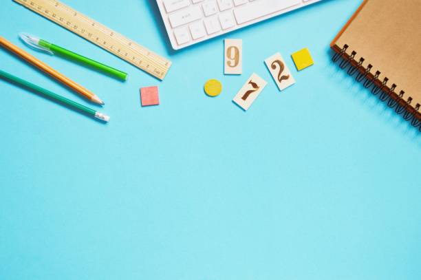 istock School table top view photo. Pen, pencil, computer keyboard, cards with numbers and notepad. Back to school photo, mockup, copy space 1268848532