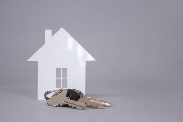 istock Home keys on a gray background with paper House. 1268858708