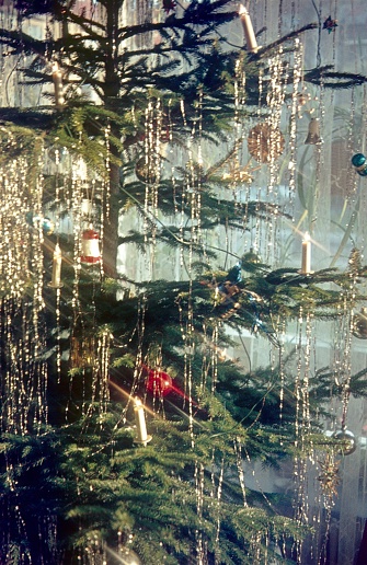 Germany, 1965. Christmas tree decorated with electric fairy lights.