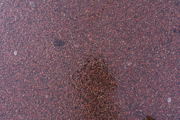 istock wet asphalt. gray coarse fabric 1268864517