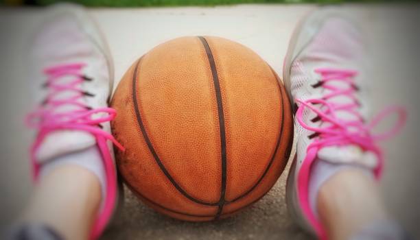 istock A basketball between the sneakers 1268872542