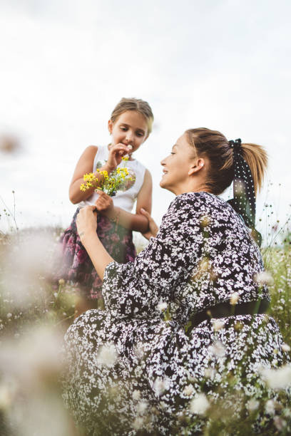Cheerful mother playing with her daughter outdoor