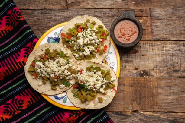 istock Mexican nopal cactus tacos with cheese on wooden background 1268881964