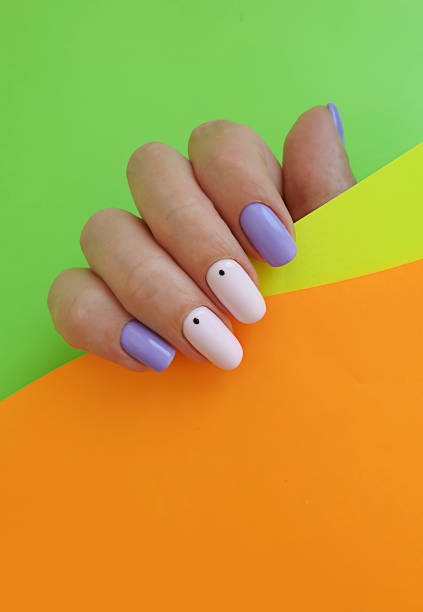istock female hand beautiful manicure on a colored background 1268882017