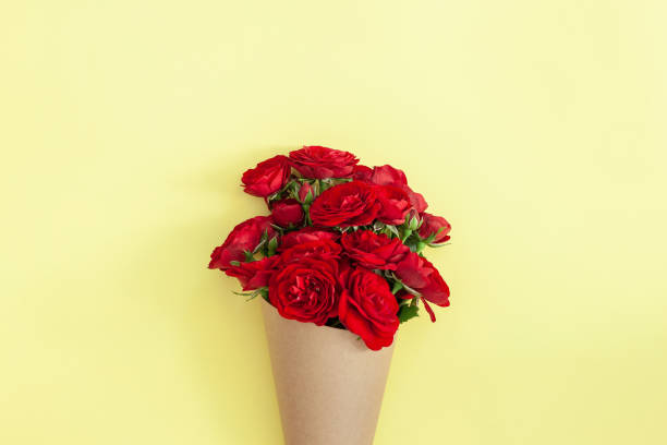 istock Red rose bouquet wrapped vintage craft paper. 1268884788