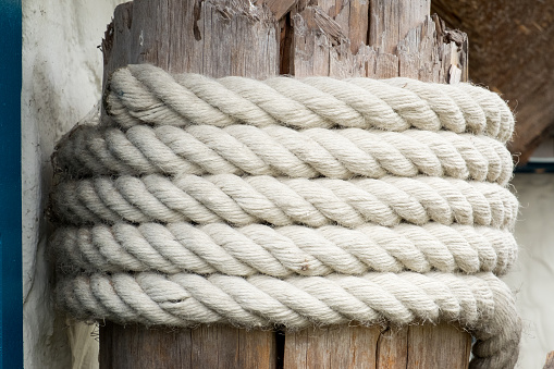 Nautical background rope covering an old wooden pole