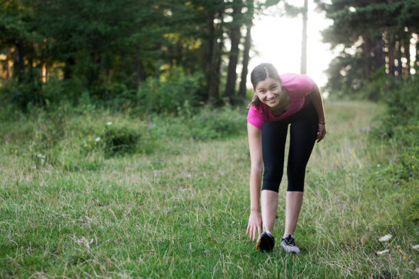 istock Young woman stretching body after jogging 1268890829