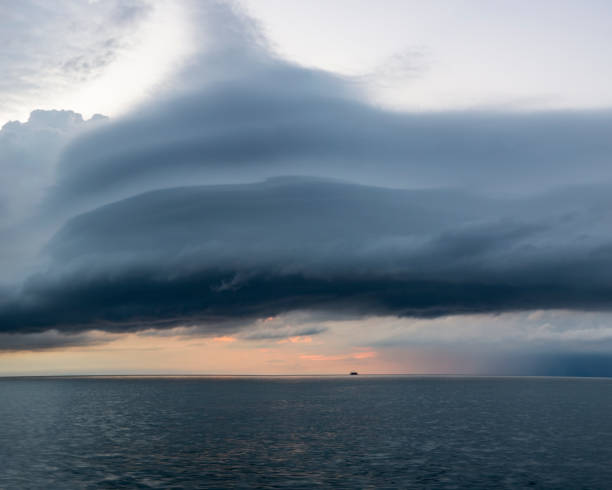 istock Dramatic Clouds at Sunrise over the Water 1268890853