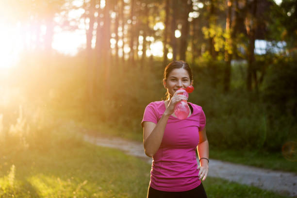 istock Sportswoman drinking water 1268890855