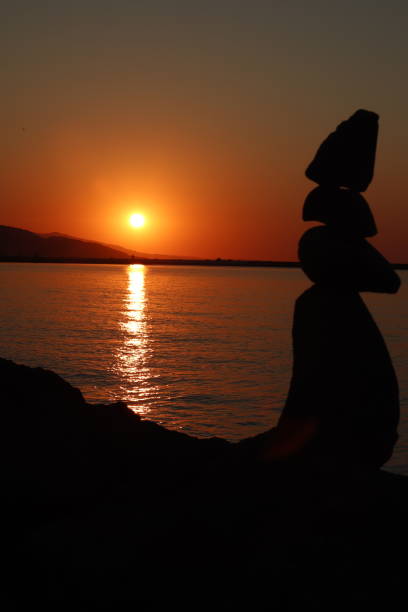 istock sunset sea and stones silhouette 1268894207
