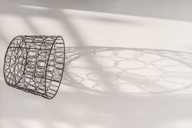 black and white oval with a mesh pattern. symmetrical geometric black and white pattern. a white egg in the shadow with a pattern. achromatic colorless artistic background