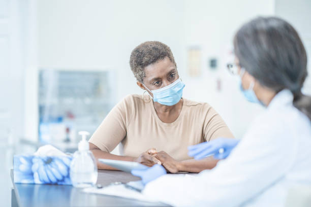 istock Medical appointment wearing face masks 1268896738