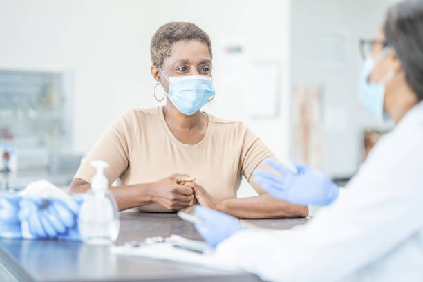 istock Medical appointment wearing face masks 1268896740