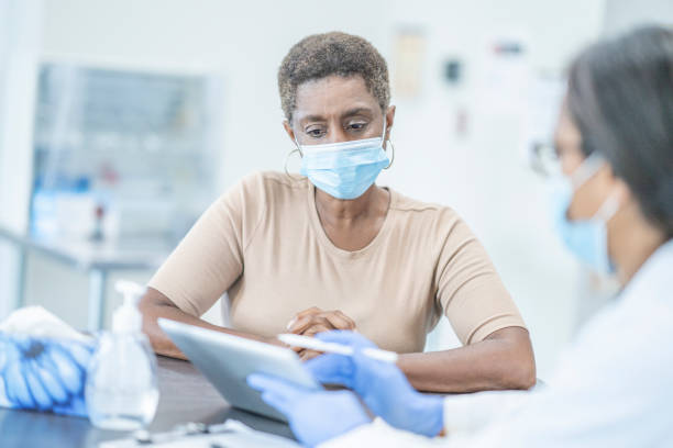 istock Medical appointment wearing face masks 1268896742