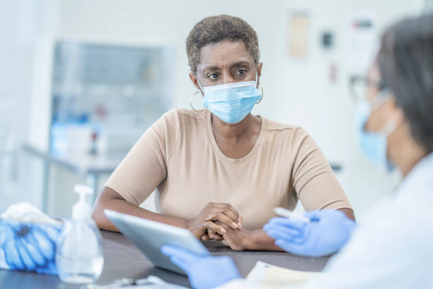 istock Medical appointment wearing face masks 1268896747
