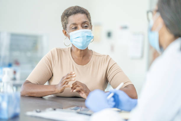 istock Medical appointment wearing face masks 1268896752