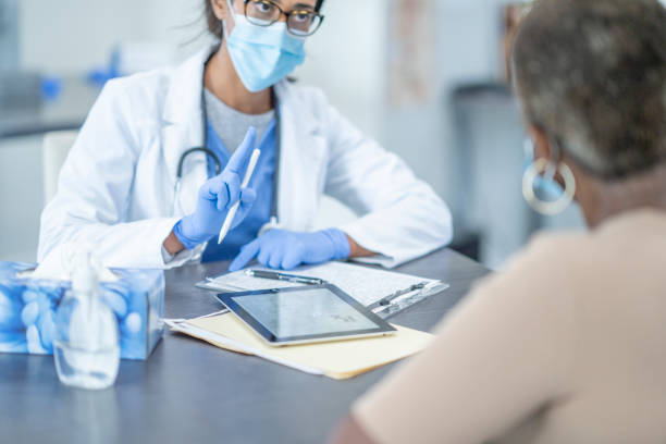 istock Medical appointment wearing face masks 1268896756
