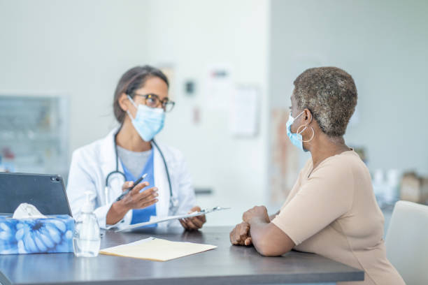 istock Medical appointment wearing face masks 1268896760